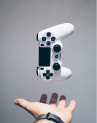 Image of a game controller in a person's hand.